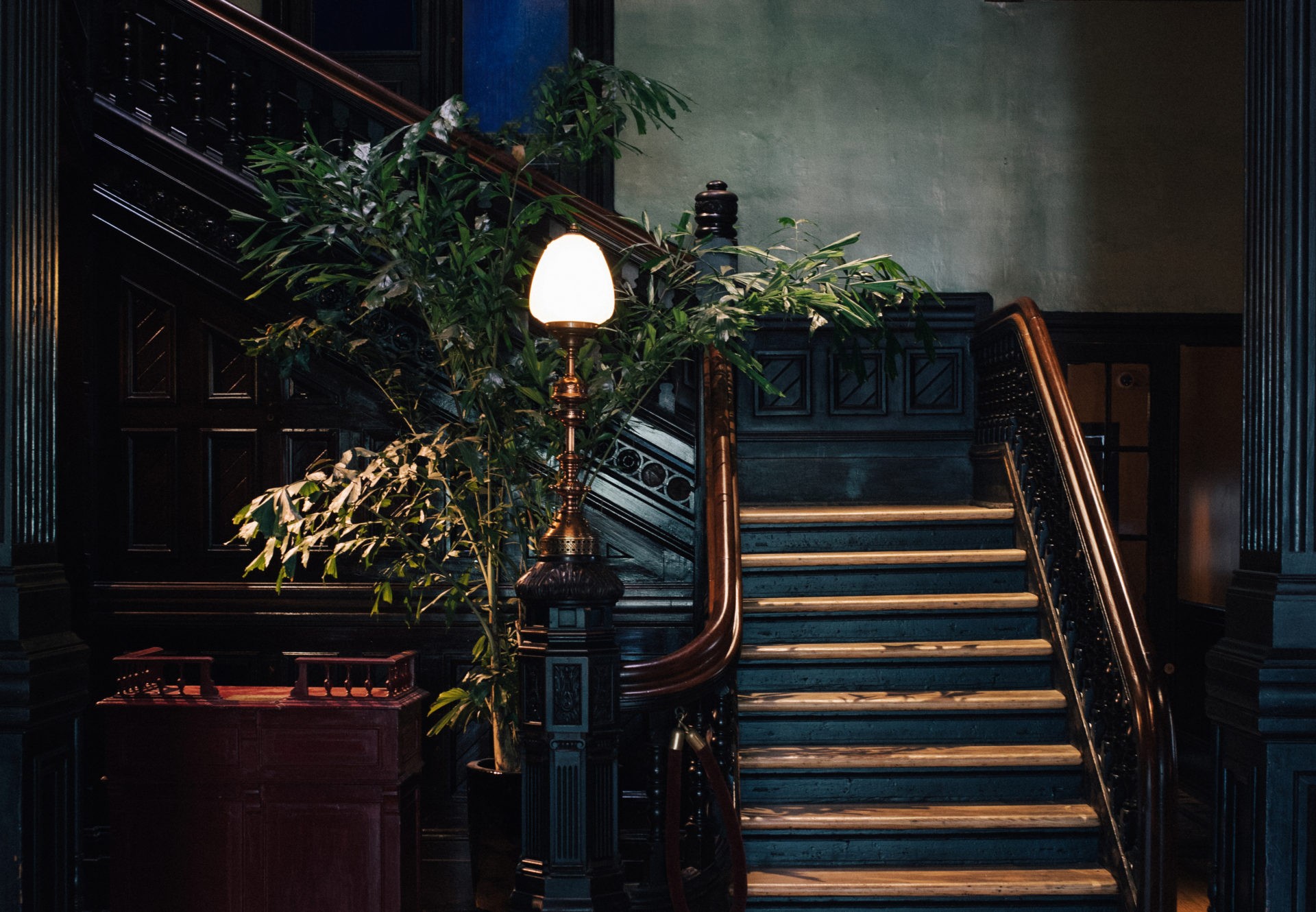 Cropped photo of the exterior of the top floor of an old stone building.